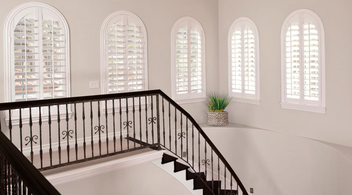 Plantation shutters on arched windows